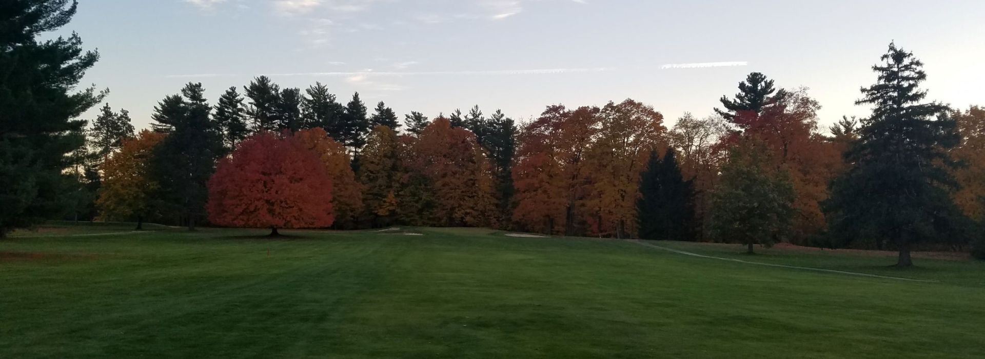 Golf course with autumnal trees